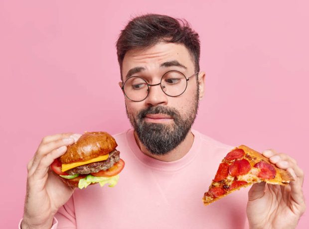 image-man-feels-hesitant-whether-eat-hamburger-pizza-prefers-eating-junk-food-wears-round-spectacles-jumper-pic_32ratio_900x600-900x600-28985